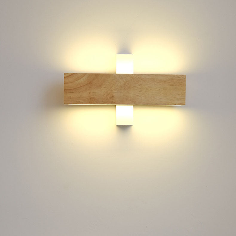 Wooden bar positioned horizontally across the white mount, lit with warm light radiating from the support above and below. 12