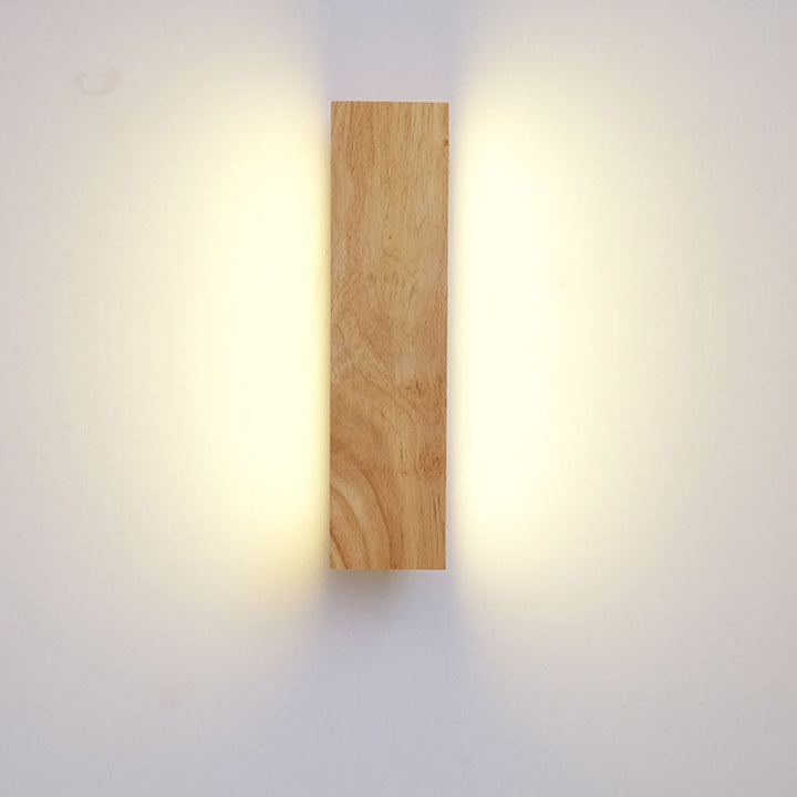 Front view of the vertical wooden wall lamp with soft light spreading up and down along both sides. 3