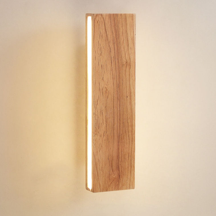 Close-up of the vertical wooden lamp showing the pronounced wood grain and a glowing light strip along its side. 14