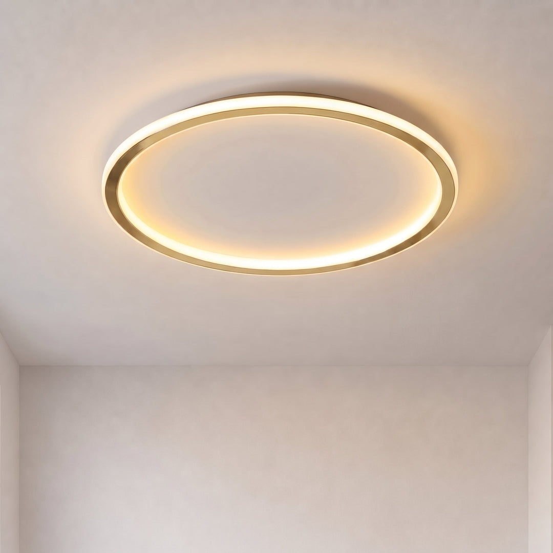 Włączona lampa w kształcie złotego pierścienia na białym suficie, widok z dołu, ciepłe światło 1